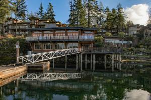 a house on a bridge over a body of water at Painted Boat Resort Spa and Marina in Madeira Park