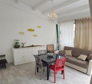 a living room with a table and chairs and a couch at Da Giovanna a Marzamemi in Marzamemi