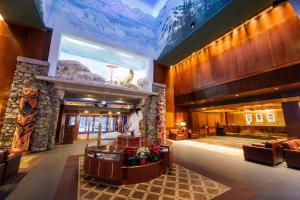 a lobby of a hotel with a large stone fireplace at Alyeska Resort in Girdwood