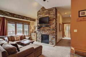 a living room with a couch and a fireplace at 8912 The Springs Condo in Keystone