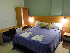Ένα ή περισσότερα κρεβάτια σε δωμάτιο στο Hotel Puesta del Sol by Nobile