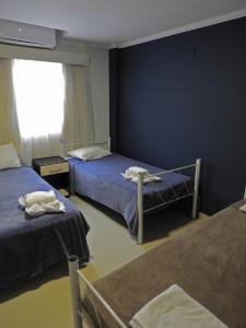 Ένα ή περισσότερα κρεβάτια σε δωμάτιο στο Hotel Puesta del Sol by Nobile