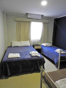 Ένα ή περισσότερα κρεβάτια σε δωμάτιο στο Hotel Puesta del Sol by Nobile