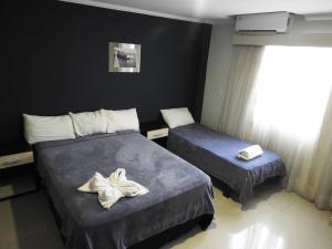 Ένα ή περισσότερα κρεβάτια σε δωμάτιο στο Hotel Puesta del Sol by Nobile