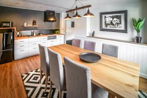 a kitchen with a wooden table and chairs at Hotel Villa Hakuba in Hakuba