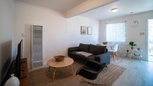 a living room with a couch and a table at Charming 2BR Casita in Front of Park in Los Angeles