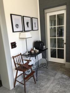 a room with a desk and a chair and a lamp at Kings Cottage Uralla in Uralla