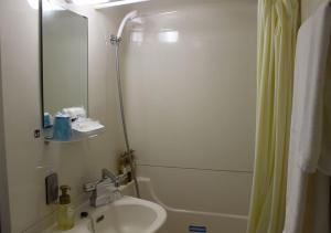 a bathroom with a sink and a toilet and a shower at Hotel Sunshine Iwaki in Iwaki +12 photos