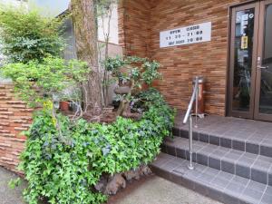 a house with a bunch of plants on the steps at Hakone Miyanoshita Myojokan in Hakone