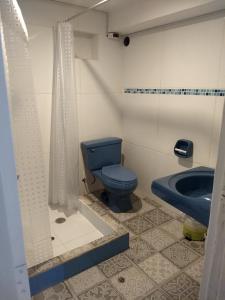 uma casa de banho com um WC azul e um lavatório. em Cusco`s Flat 2 em Cusco