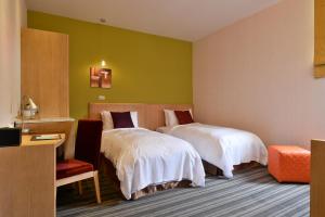 Postel nebo postele na pokoji v ubytování In Young Hotel