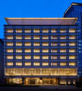 an office building with illuminated windows at night at THE KITANO HOTEL TOKYO in Tokyo