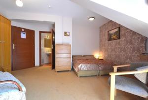 a bedroom with a bed and a stair case at Willa Zarębek in Łopuszna