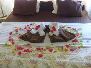 a cake of a pair of shoes on a bed at Cazhibiscus in Trou aux Biches