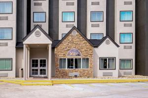 a building with a house in front of it at Quality Inn & Suites in Robbinsville