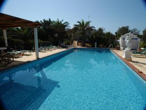a swimming pool with blue water in a resort at Oasi Di Casablanca in Lampedusa