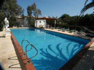 a swimming pool with blue water in a house at Oasi Di Casablanca in Lampedusa