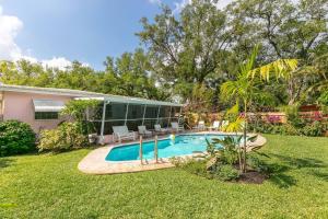 a house with a swimming pool in the yard at Floral Oasis in Fort Lauderdale