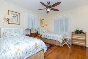 a bedroom with two beds and a ceiling fan at Floral Oasis in Fort Lauderdale
