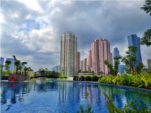 une grande piscine dans une ville avec de grands bâtiments dans l'établissement Swiss-Belresidences Rasuna Epicentrum, à Jakarta