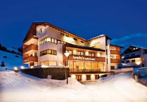 a large building in the snow at night at Apart Rubin in Serfaus