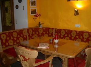 a table and a couch in a room with a table at Ferienwohnung Moll in Balderschwang