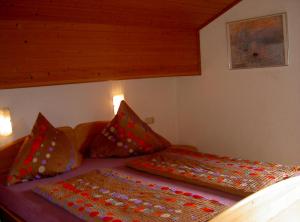 a bed in a room with two pillows on it at Ferienwohnung Moll in Balderschwang