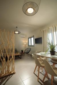 a living room with a table and chairs at Sweet Home Naxos in Naxos Chora