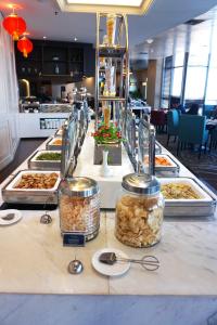 a buffet line with many different types of food at Swiss-Belhotel Airport Jakarta in Tangerang
