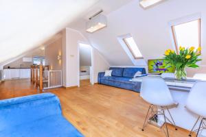 a large living room with a blue couch and chairs at Apartament Olivia Chlapowo/Wladyslawowo in Władysławowo