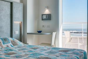 a bedroom with a bed and a view of the ocean at Hotel Asiago Beach in Lido di Savio +38 photos