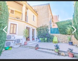 a house with a patio with plants in front of it at Benidorm holiday rental in Cala de Finestrat