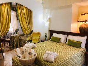 Postel nebo postele na pokoji v ubytování Hotel Astigiana & Appartamenti