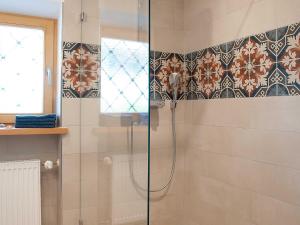 a shower with a glass door in a bathroom at Ferienwohnung Ulrich Wurmser in Rottach-Egern
