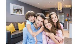 a family posing for a picture in a living room at Dream Apartments St Thomas Hall in Belfast