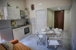 a kitchen and dining room with a table and chairs at Luxury View Apartment in Casola di Napoli +15 photos