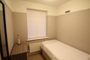 a small bedroom with a bed and a window at Oak Tree in London