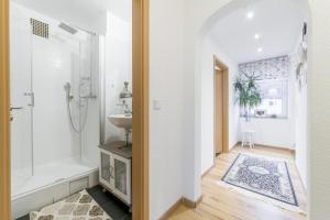 a white bathroom with a shower and a sink at Private House in Hannover
