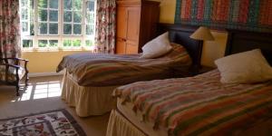 a hotel room with two beds and a window at Inversanda Farm Cottages in Dargle
