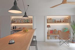 a kitchen with a large wooden table and chairs at Aparthotel Niu d´Aus in Portopetro