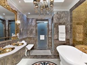 a bathroom with a toilet, sink, and bathtub at The St. Regis Moscow Nikolskaya in Moscow