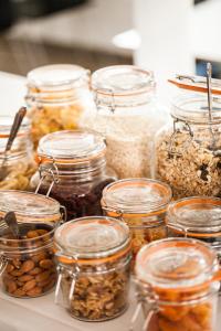 a group of jars filled with nuts and seeds at Femmasteren Hotel & Hostel in Marstal