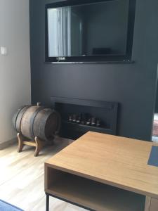 a room with a barrel and a table and a mirror at Destine in Rogoznica