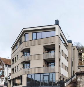 an apartment building with balconies and windows at Luis & die Buabm - Gasthof Jenesien in San Genesio Atesino