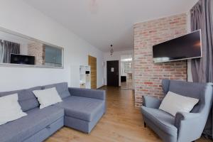 a living room with a couch and two chairs at ShortStayPoland Marymoncka in Warsaw