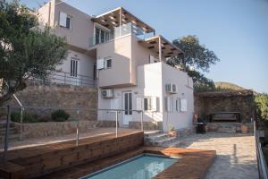 a villa with a swimming pool and a house at Halcyon Panorama Villas in Agios Nikolaos