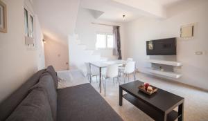 a living room with a couch and a table at Halcyon Panorama Villas in Agios Nikolaos