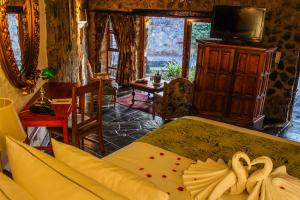 a bedroom with a bed with two swans on it at Misty Hills Country Hotel, Conference Centre & Spa in Muldersdrift
