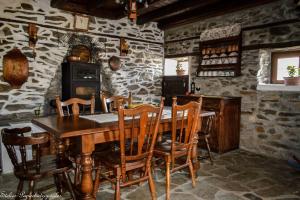 a dining room with a wooden table and chairs at Mansion Philoktitis in Melívoia