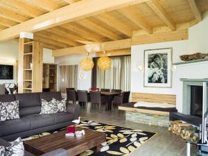 a living room with a couch and a fireplace at AlpenParks Residence Zell am See in Zell am See